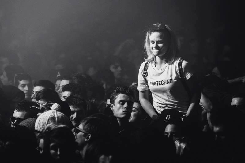 Blonde girl raving to techno at a club - wide 1